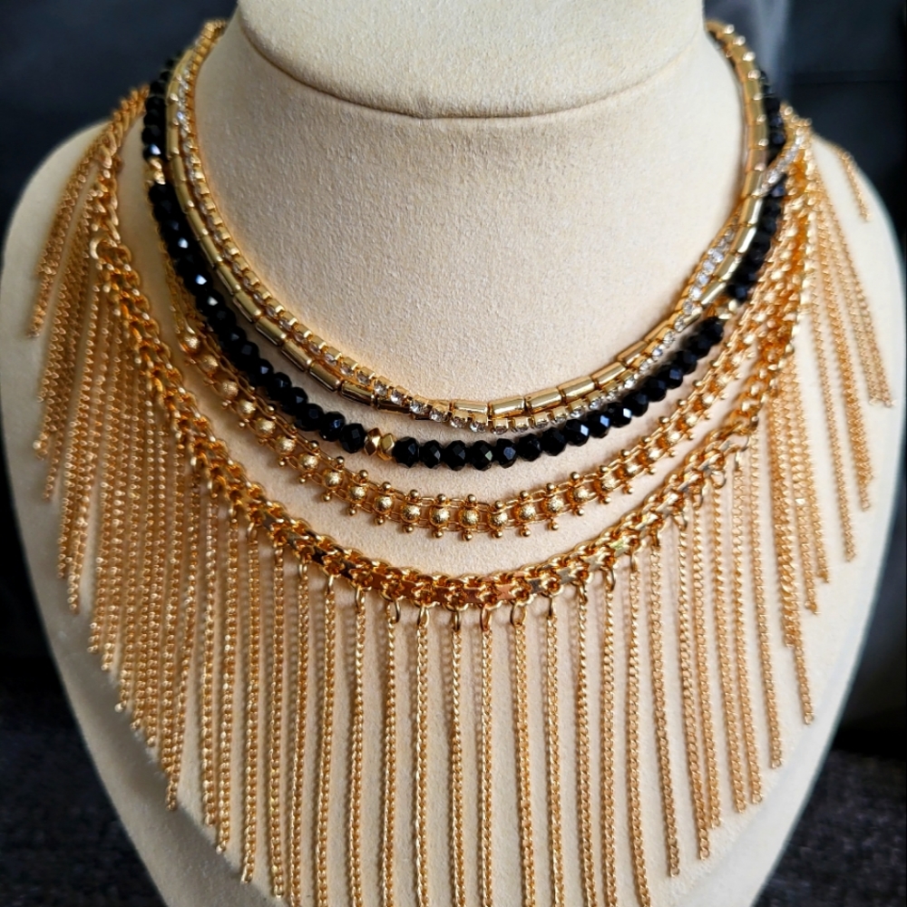 A gold tone Aldo chocker set of 3 with the original packaging